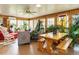 Bright sunroom filled with plants, wood paneling, and comfortable seating at 3680 15-501 N, Pittsboro, NC 27312