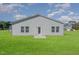 Backyard featuring a neatly maintained lawn and the exterior of the home at 402 Suhani Ln, Clayton, NC 27520