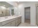 Stylish bathroom features a double sink vanity, and walk-in closet adjacent to a modern glass shower at 402 Suhani Ln, Clayton, NC 27520