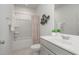 Bathroom with a bathtub-shower combination and a well-lit vanity, designed for comfort at 402 Suhani Ln, Clayton, NC 27520