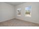 Bright, carpeted bedroom featuring two windows offering lots of natural light at 402 Suhani Ln, Clayton, NC 27520