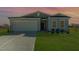 Charming single-Gathering home featuring a two-car garage and well-manicured lawn at dusk at 402 Suhani Ln, Clayton, NC 27520