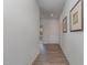 Inviting home hallway featuring wood floors and neutral paint at 402 Suhani Ln, Clayton, NC 27520