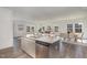 Modern kitchen with stainless steel appliances, granite countertops, and an open view to the living area at 402 Suhani Ln, Clayton, NC 27520