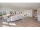 Open-concept living room featuring neutral furniture, wood floors, and an adjacent dining area at 402 Suhani Ln, Clayton, NC 27520