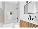 Sleek bathroom featuring white subway tile, a modern vanity, and black fixtures offers a luxurious and contemporary space at 409 Alston St # 101, Raleigh, NC 27601