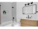 Sleek bathroom featuring white subway tile, a modern vanity, and black fixtures offers a luxurious and contemporary space at 409 Alston St # 101, Raleigh, NC 27601