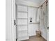 Organized walk-in closet with built-in shelving, hanging rods, and herringbone floors at 409 Alston St # 101, Raleigh, NC 27601