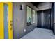 Modern home exterior with a vibrant yellow door and unique architectural details at 409 Alston St # 101, Raleigh, NC 27601