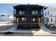 Modern two-story home with black siding, yellow doors, and minimalist landscaping at 409 Alston St # 101, Raleigh, NC 27601