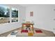 Bright home office featuring a modern desk, colorful rug, and a large window view at 409 Alston St # 101, Raleigh, NC 27601