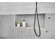 Close-up of modern shower with gray tiled walls, niche, and matte black shower head at 409 Alston St # 101, Raleigh, NC 27601