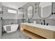 Modern bathroom featuring double sinks, sleek fixtures, a soaking tub, and stylish tile at 409 Alston St # 102, Raleigh, NC 27601