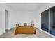 Bright bedroom features a large sliding door, hardwood floors, and a neutral color palette at 409 Alston St # 102, Raleigh, NC 27601