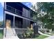 Modern home showcasing black vertical siding, yellow door, and sleek landscaping at 409 Alston St # 102, Raleigh, NC 27601