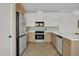 Kitchen featuring stainless steel appliances, white countertops, and wood finish cabinets at 409 Alston St # 102, Raleigh, NC 27601