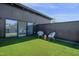 Inviting rooftop patio with artificial grass, seating area, and sliding glass door for seamless indoor/outdoor living at 409 Alston St # 102, Raleigh, NC 27601
