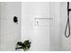 Modern shower featuring white subway tile, black shower head, and inset shelf at 409 Alston St # 102, Raleigh, NC 27601