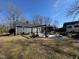 An expansive backyard featuring a patio with pergola, perfect for outdoor living and entertaining at 472 Cedar Ln, Mebane, NC 27302