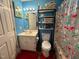 A cozy bathroom with a single sink, vanity, overhead lighting, and a cherry-themed shower curtain at 472 Cedar Ln, Mebane, NC 27302