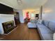 Cozy living room featuring a fireplace, hardwood floors, and an open floor plan to the dining area at 472 Cedar Ln, Mebane, NC 27302