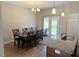 Dining area features a table with seating for eight, adjacent to the kitchen island and sliding glass door at 495 Cheves Rd # 495, Zebulon, NC 27597