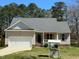 Front exterior showcasing a cozy single-Gathering home with a well-kept lawn and attached garage at 495 Cheves Rd # 495, Zebulon, NC 27597