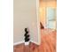 Hallway with durable wood floors, neutral walls, and an accent plant at 495 Cheves Rd # 495, Zebulon, NC 27597