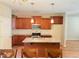 Kitchen features dark wood cabinets, granite countertops, stainless steel appliances, and a center island at 495 Cheves Rd # 495, Zebulon, NC 27597