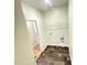 This laundry room has wood-look floors and has washer/dryer hookups and white wire shelving at 495 Cheves Rd # 495, Zebulon, NC 27597