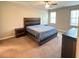 This bedroom boasts a ceiling fan, natural light, and a striking wood-paneled bedframe with matching furniture at 495 Cheves Rd # 495, Zebulon, NC 27597