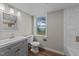 Bright bathroom features a vanity, tiled walls, modern sink and a window with a view at 539 N Oneil St, Clayton, NC 27520