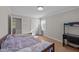 Comfortable bedroom features hardwood floors and a desk near the sliding-door closet at 539 N Oneil St, Clayton, NC 27520