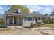Single-story house boasting grey brick exterior, classic black shutters, and a convenient covered carport at 539 N Oneil St, Clayton, NC 27520