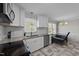 Well-lit kitchen featuring white cabinets, granite countertops, and stainless steel appliances at 539 N Oneil St, Clayton, NC 27520