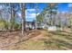 Spacious backyard with a deck, shed, and mature trees, offering privacy and space at 5508 Lake Garden Ct, Raleigh, NC 27610