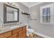 Charming bathroom with a granite countertop vanity, framed mirror, and a window for natural light at 5508 Lake Garden Ct, Raleigh, NC 27610