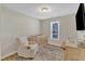 Neutral Bedroom space with crib, comfortable armchair, and a window for natural light at 5508 Lake Garden Ct, Raleigh, NC 27610