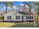 Charming one-story home featuring a well-manicured lawn and classic white siding with black shutter accents at 5508 Lake Garden Ct, Raleigh, NC 27610