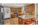Functional kitchen featuring wooden cabinets, stainless steel appliances, and a breakfast bar with seating at 5508 Lake Garden Ct, Raleigh, NC 27610