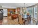 Kitchen and dining area featuring wood cabinets, stone countertops, and natural light from many windows at 5508 Lake Garden Ct, Raleigh, NC 27610