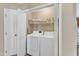Convenient laundry closet with washer, dryer, and overhead storage shelves at 5508 Lake Garden Ct, Raleigh, NC 27610