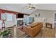 Bright living room with a fireplace, wood-look flooring, and a comfortable leather sofa at 5508 Lake Garden Ct, Raleigh, NC 27610