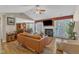 Open-concept living room features a fireplace, vaulted ceilings, and seamless flow into dining area at 5508 Lake Garden Ct, Raleigh, NC 27610
