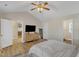 Relaxing main bedroom with a ceiling fan, rug, minimalist furniture, and entry to main bathroom at 5508 Lake Garden Ct, Raleigh, NC 27610