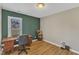 Bright home office with a large window and an accent wall at 5508 Lake Garden Ct, Raleigh, NC 27610