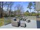 Relax outdoors on this spacious deck with stylish patio furniture and scenic backyard views at 5705 Dean Ave, Raleigh, NC 27616