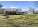 Expansive backyard with a deck, brick house, and detached garage, perfect for outdoor living at 5705 Dean Ave, Raleigh, NC 27616