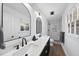 Modern bathroom with double sink vanity, updated lighting, and a glass-enclosed shower at 5705 Dean Ave, Raleigh, NC 27616
