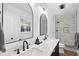 Modern bathroom featuring dual sinks, updated fixtures and sleek tiled shower at 5705 Dean Ave, Raleigh, NC 27616